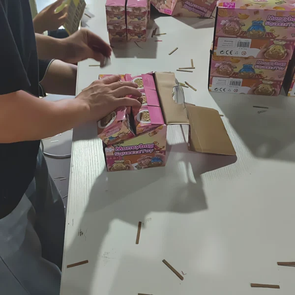 Warehouse operators placing labeled product packages into outer cartons for repacking