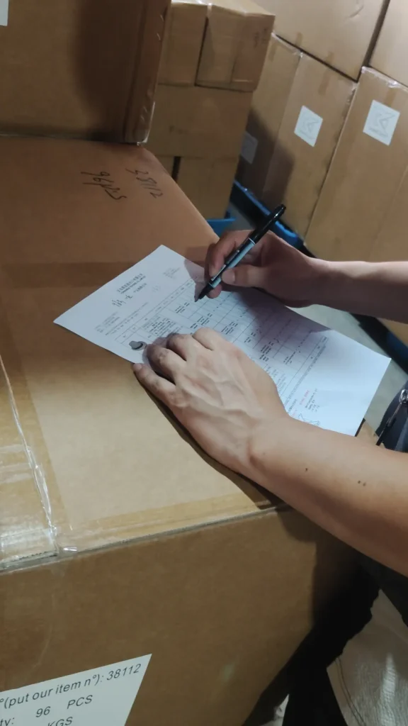 Warehouse staff checking supplier delivery records in China