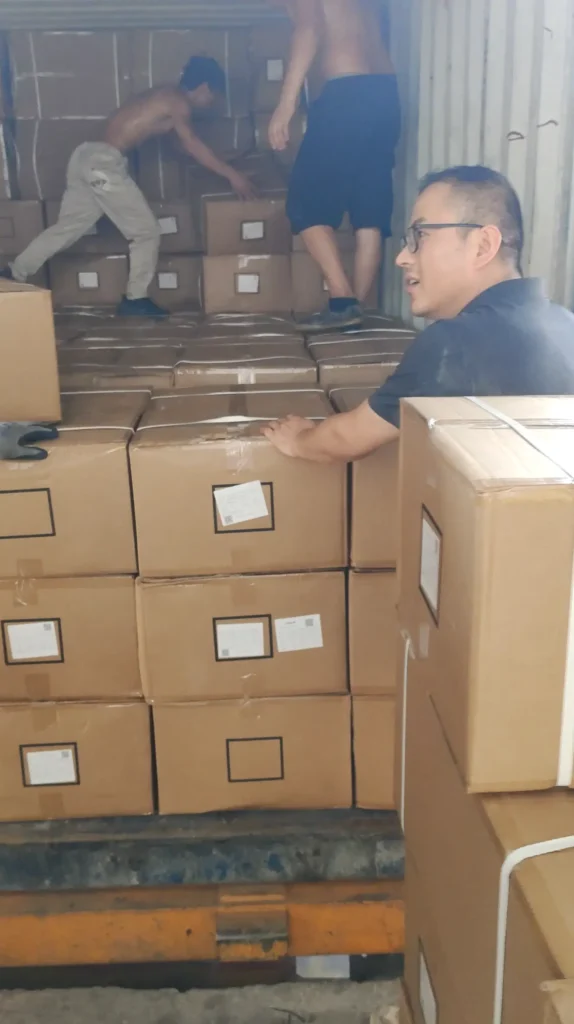 A 20GP container partially loaded with export cartons during warehouse operations.