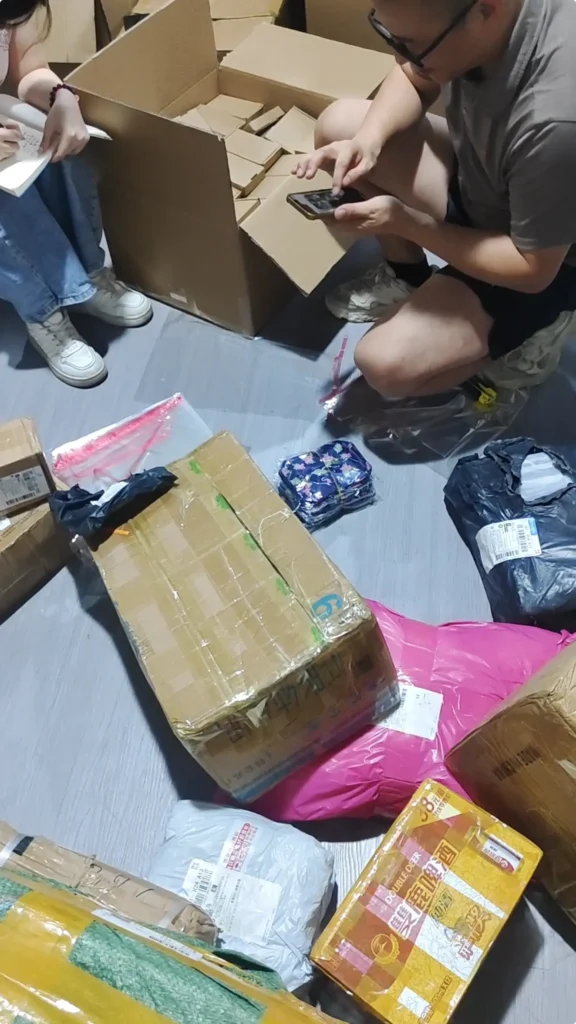 Worker sealing a carton during product repacking for international shipping preparation