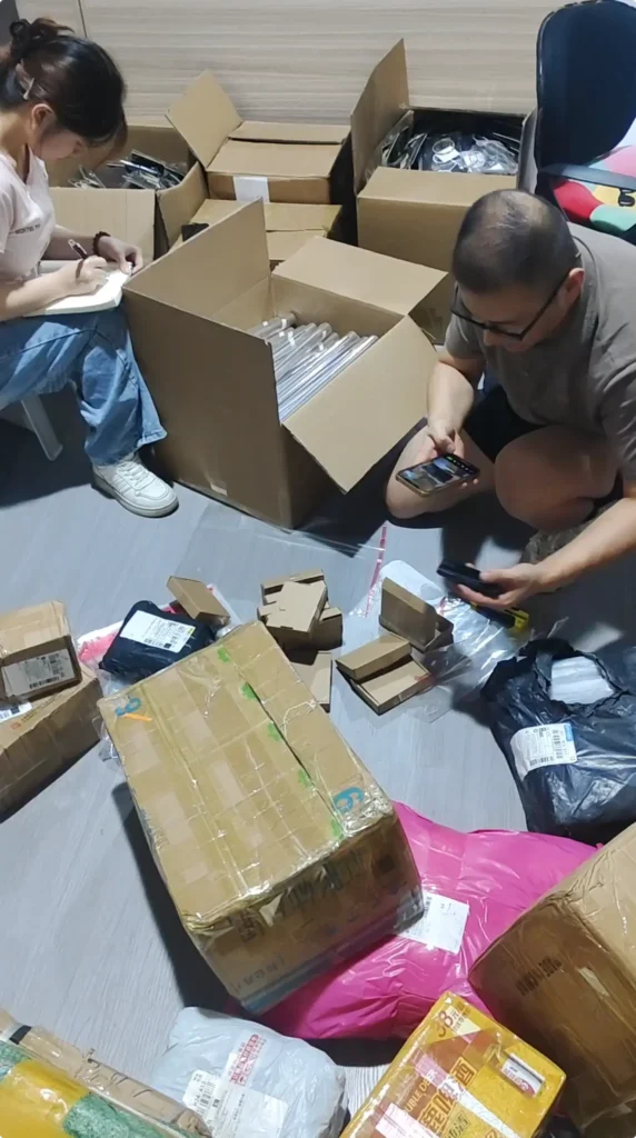 Warehouse staff sorting and recording customer products before shipment preparation