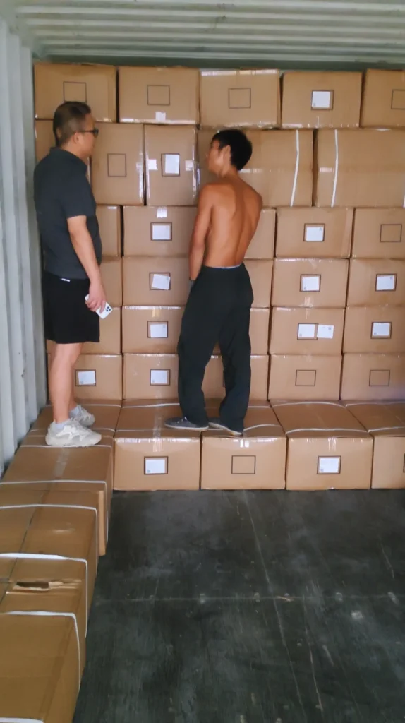 Warehouse supervisor discussing the loading plan with the container loading team.