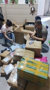 Warehouse staff sorting and recording customer products before shipment preparation