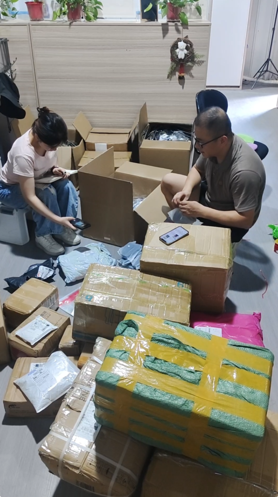 Warehouse staff sorting and recording customer products before shipment preparation