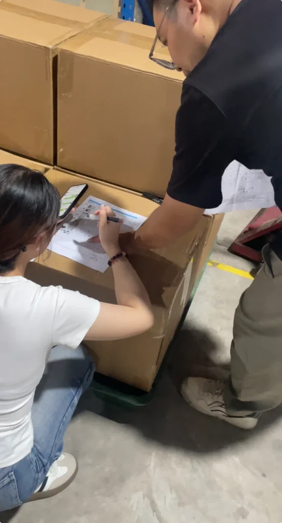 Warehouse team confirming carton count with supplier