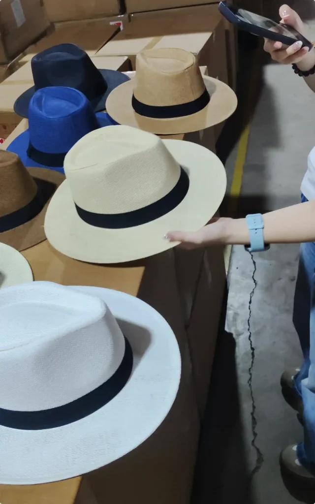 Warehouse team inspecting British-style hats